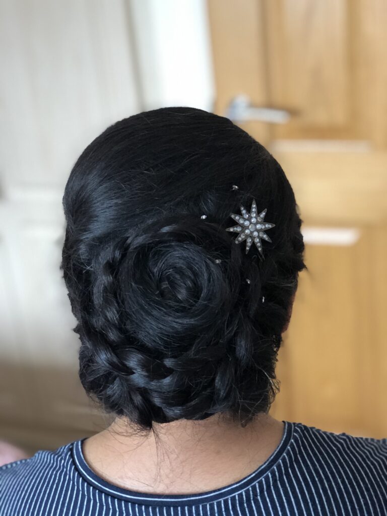 Long thick Asian hair braided and twisted into an updo. creating a textued luxury spiral with added celestial sparkle accessories.
