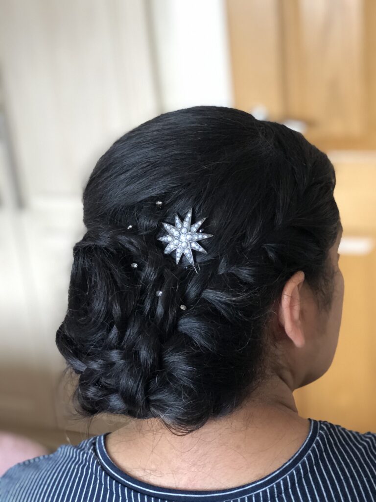 Long thick Asian hair braided and twisted into an updo. creating a textued luxury spiral with added celestial sparkle accessories