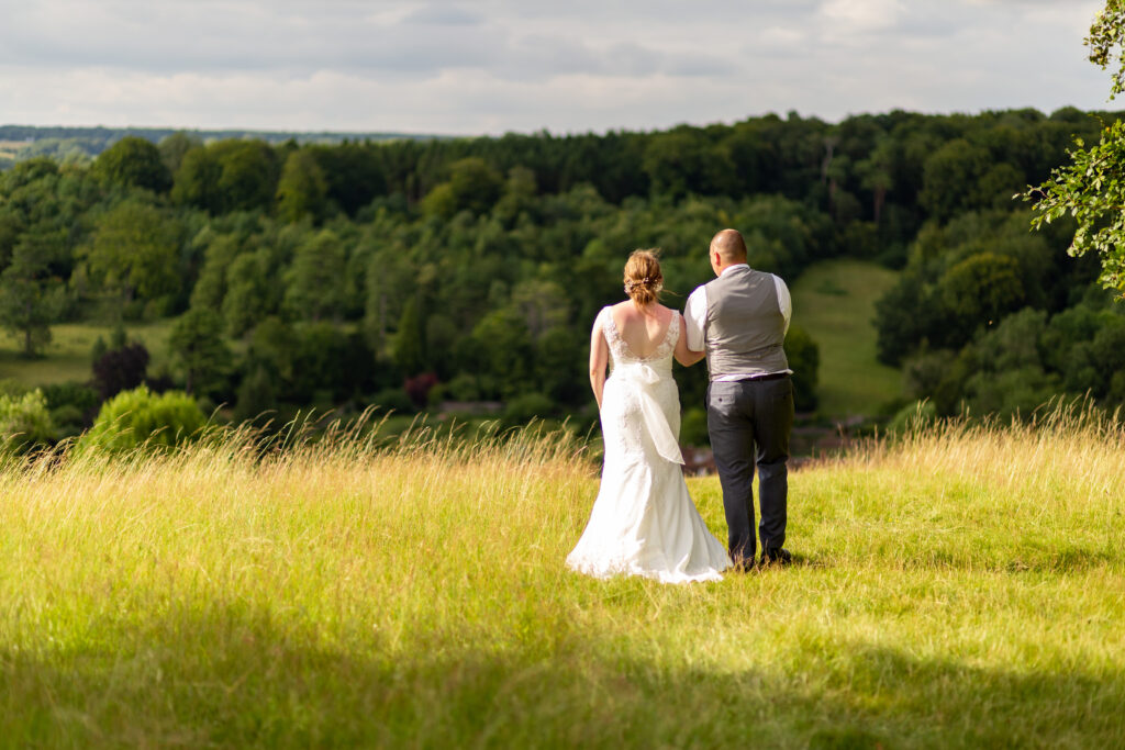 Newly weds over looking the valley at Stonor Park. Lots of lush green fields