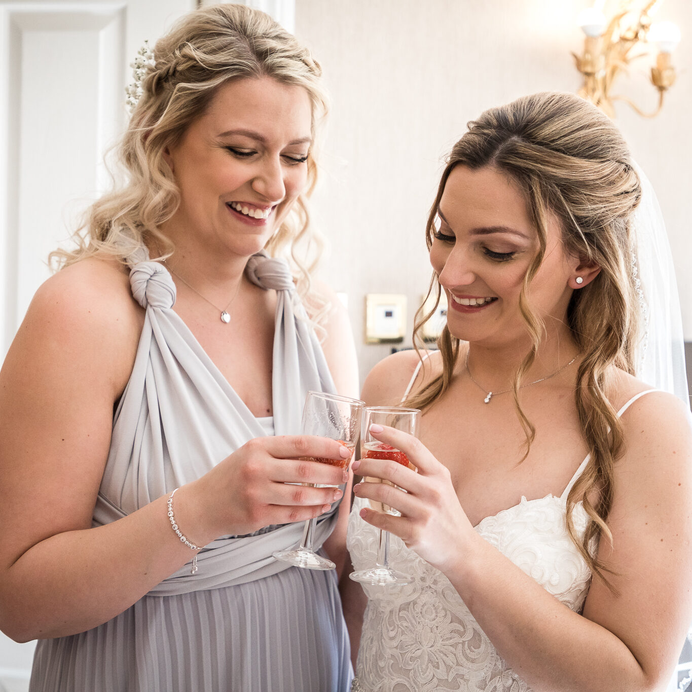 Bride and maid of honour cheers now they are all ready for the day